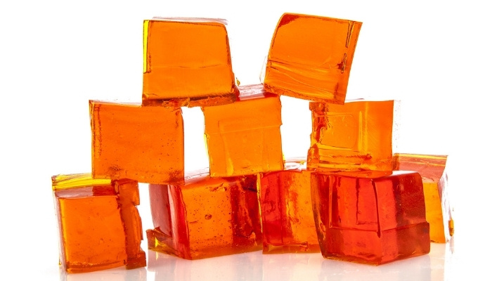 Cubes of orange jello stacked like building blocks.