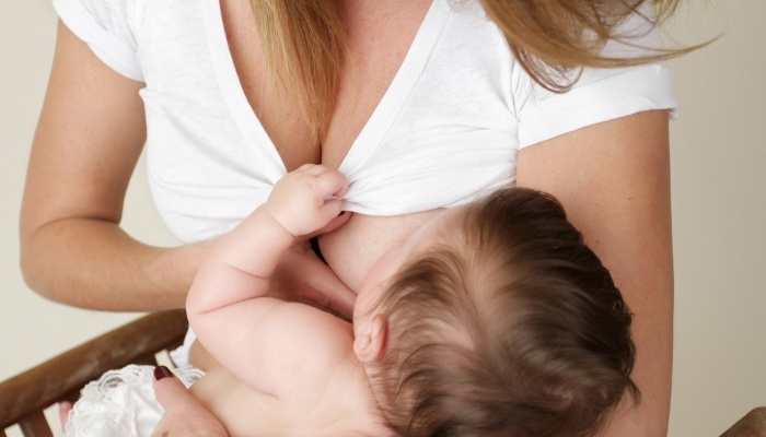 Mother nursing her baby skin to skin.