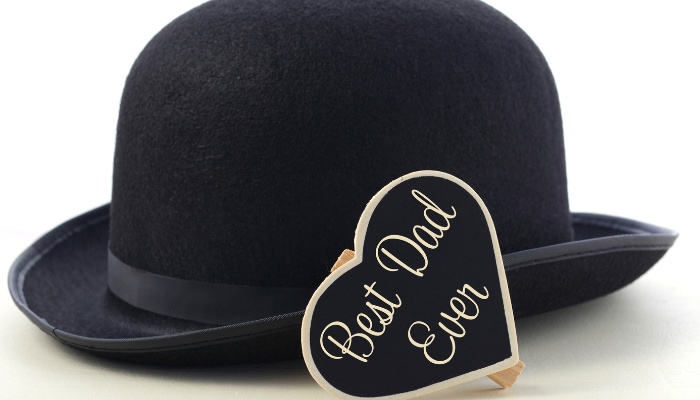 A black bowler hat with a heart-shaped sign that says Best Dad Ever.