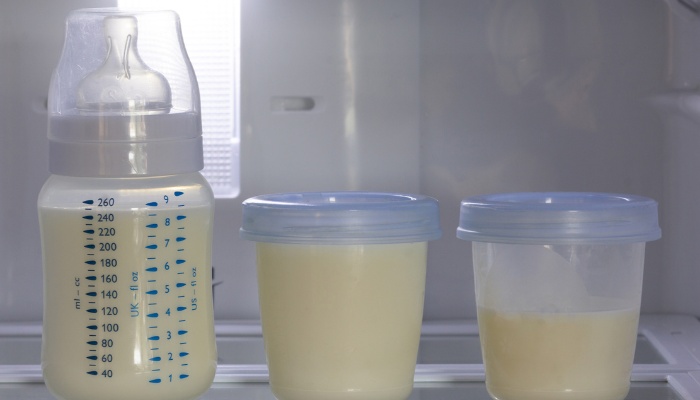 Two containers and a bottle of breast milk stored in the refrigerator.