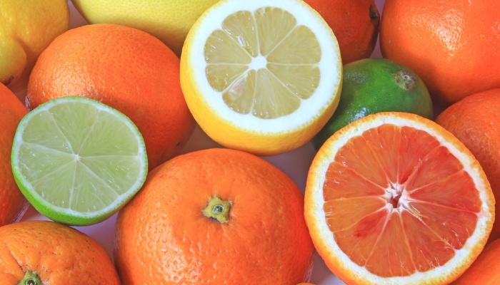A variety of citrus fruits including limes, oranges, and lemons.