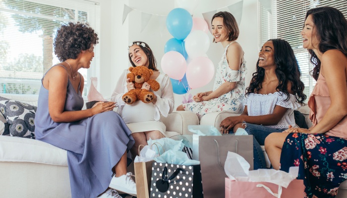 A  group of ladies enjoying a baby shower at someone's home.