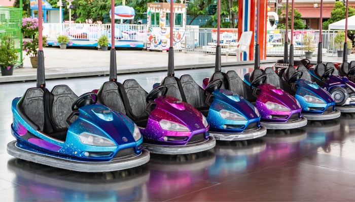 A row of colorful bumper cars at an amusement park.