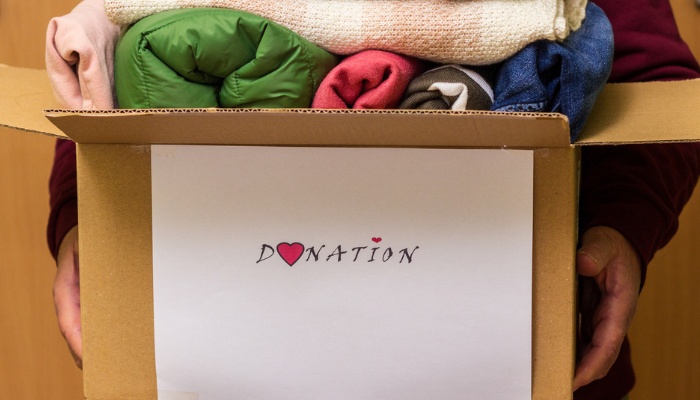 A donation box full of clothing and blankets.