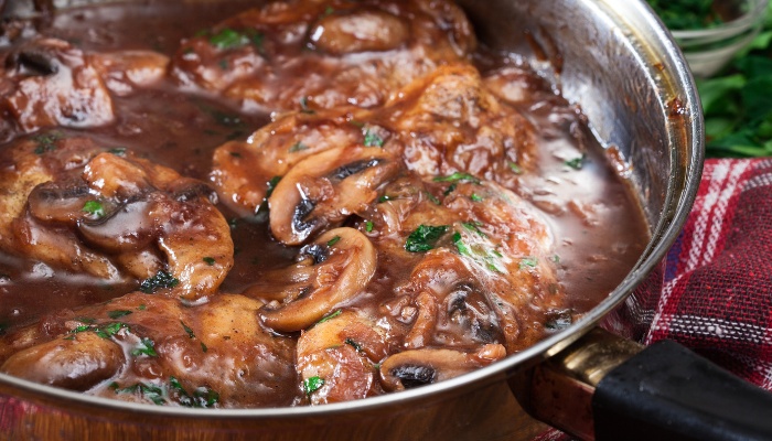 A pan of hot chicken marsala ready to serve.