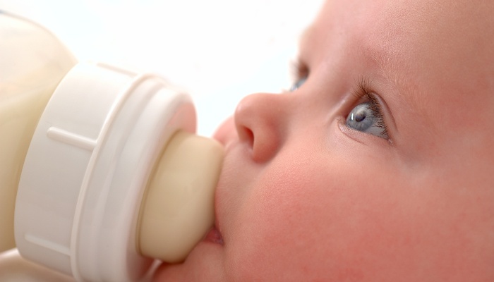 Close-up view of a beautiful baby drinking her bottle.